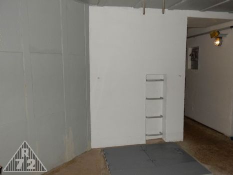 Pohled na průlez do spodního patra a oplechování čelní stěny objektu.